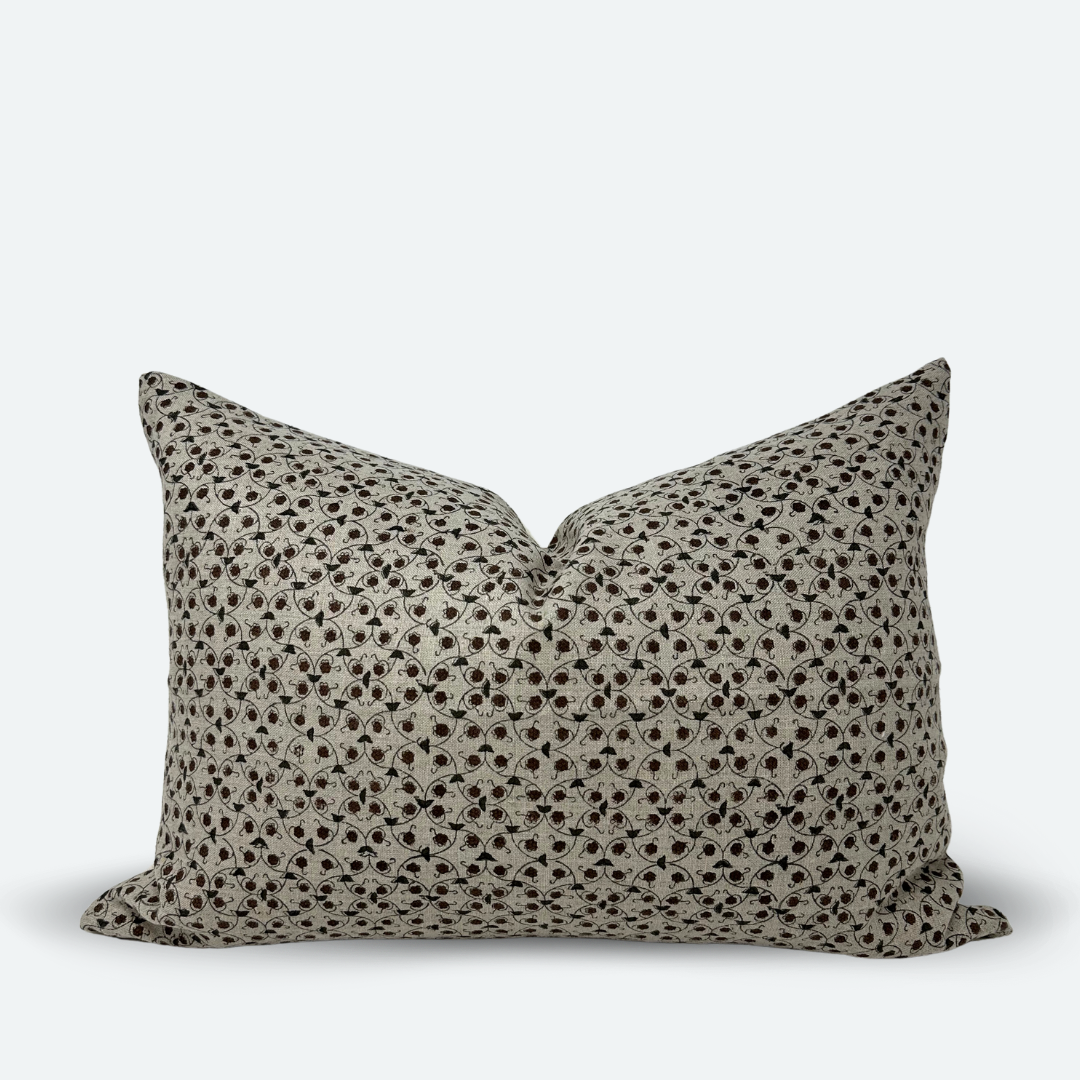 A medium-sized lumbar pillow with a chestnut and slate floral trellis block print on natural colored linen.