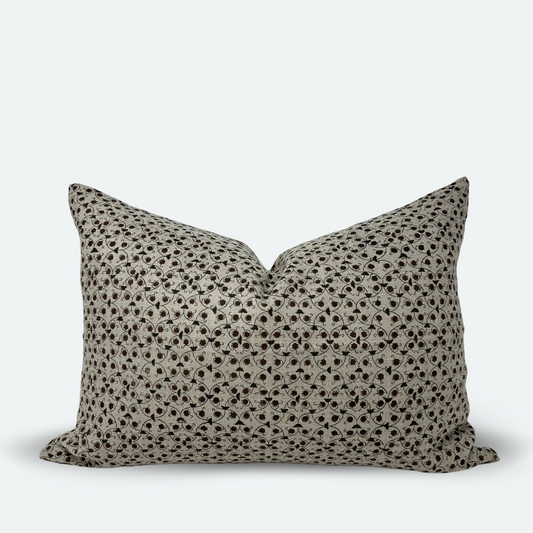 A medium-sized lumbar pillow with a chestnut and slate floral trellis block print on natural colored linen.